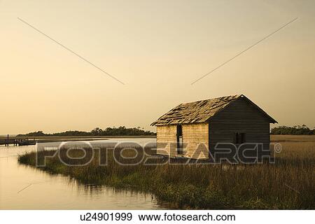 Stock Photo - Worn out building in marsh on Bald Head Island, North Carolina.. Fotosearch