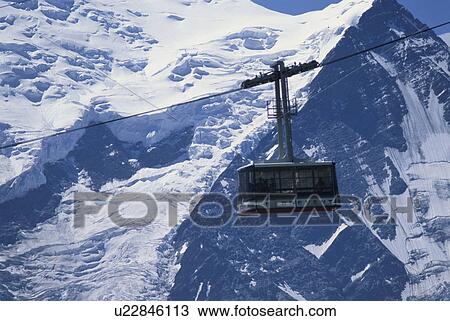 A Rope Way And The Snow-Covered Mountain In Switzerland View Large Photo Image Stock Image - A Rope Way And The Snow-Covered Mountain In Switzerland. Fotosearch