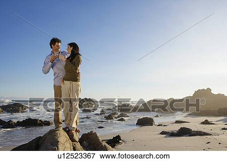 Stock Photo - Couple drinking wine at coast, Cape Town, South Africa. Fotosearch