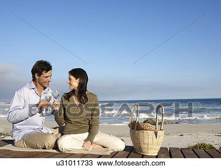 Couple drinking wine on beach, Cape Town, South Africa View Large Photo Image Stock Image - Couple drinking wine on beach, Cape Town, South Africa. Fotosearch