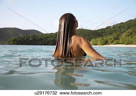 Stock Image - Mid adult woman swimming, St. John, US Virgin Islands, USA. Fotosearch