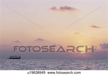 Stock Photo - The Setting Sun And The Sea. Fotosearch