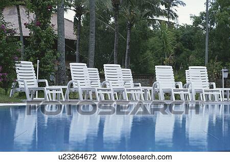 Stock Image - The White Chair At The Poolside. Fotosearch