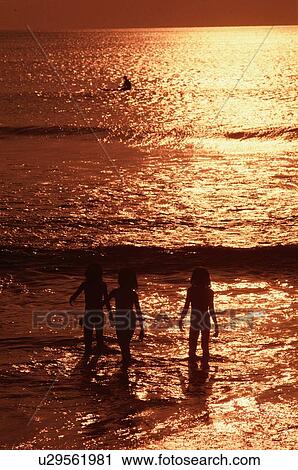 Three People Standing In Sea View Large Photo Image Stock Image - Three People Standing In Sea. Fotosearch