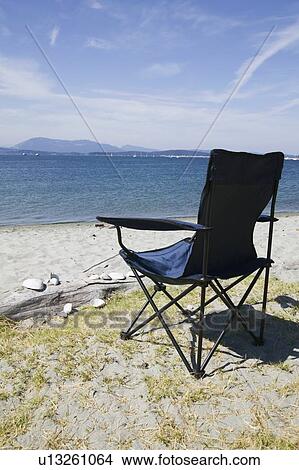 Picture - Foldable chair on the beach at Sidney Spit Marine Park, BC, Canada. Fotosearch
