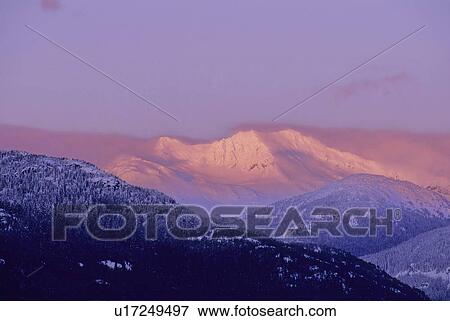 Stock Photo - Mt. Currie is lit by pink alpenglow, Whistler, BC Canada. Fotosearch