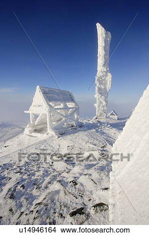 Picture - View of snow-covered shelter at top of Mont Logan at sunrise, Quebec, Canada. Fotosearch