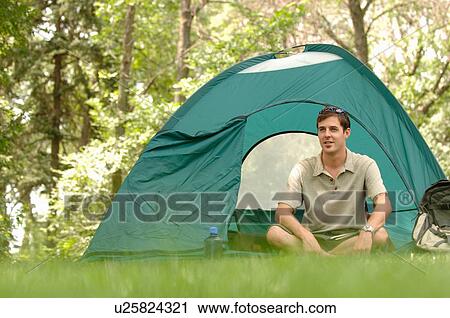 Young man sitting in front of tent, Regina, Saskatchewan View Large Photo Image Stock Image - Young man sitting in front of tent, Regina, Saskatchewan. Fotosearch