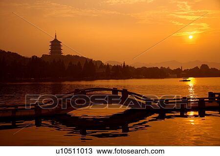 Leifeng Pagoda in Evening Glow and causeway in West Lake, Hangzhou, Zhejiang Province View Large Photo Image Stock Image - Leifeng Pagoda in Evening Glow and causeway in West Lake, Hangzhou, Zhejiang Province. Fotosearch