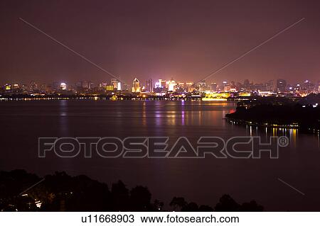 Stock Image - Scenery of West Lake at night in Hangzhou, Zhejiang Province. Fotosearch