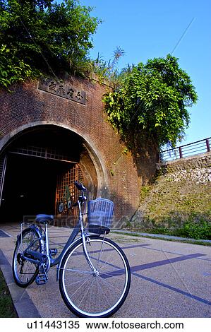 Stock Photography - A bicycle in front of tunnel entrance in Taipei County, Taiwan. Fotosearch