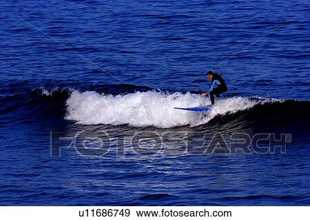 Two people surfing in Mushung Harbor, Yilan, Taiwan View Large Photo Image Stock Photo - Two people surfing in Mushung Harbor, Yilan, Taiwan. Fotosearch