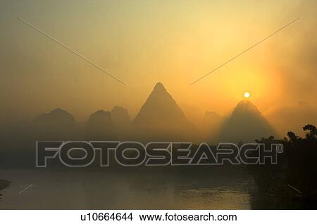 China, Guangxi Province, Guilin, Yangshuo, Li River with mountains in the mist View Large Photo Image Picture - China, Guangxi Province, Guilin, Yangshuo, Li River with mountains in the mist. Fotosearch