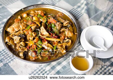 Picture - China, Guangxi Province, Guilin, Yangshuo, beer fish and stewed pork on the table. Fotosearch
