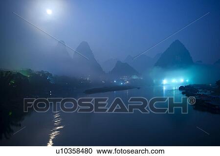 China, Guangxi Province, Guilin, Yangshuo, Li River with mountains at night View Large Photo Image Stock Image - China, Guangxi Province, Guilin, Yangshuo, Li River with mountains at night. Fotosearch