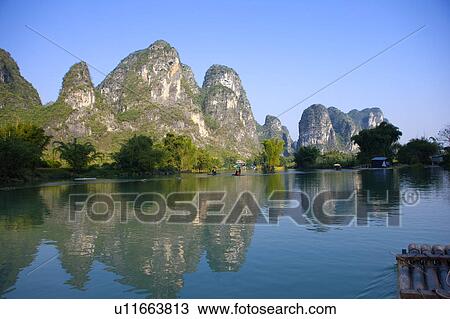 Stock Image - China, Guangxi Province, Guilin, Yangshuo, Yulong River with mountain. Fotosearch