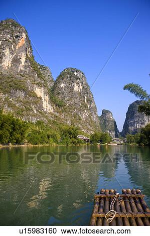 Stock Image - China, Guangxi Province, Guilin, Yangshuo, bamboo raft on Yulong River. Fotosearch
