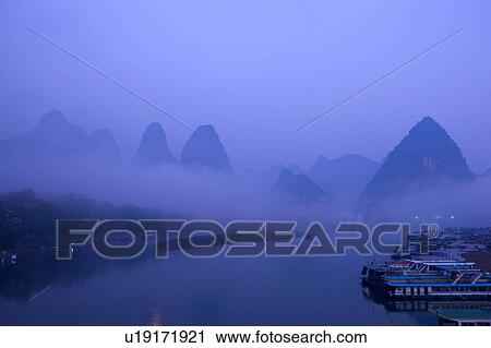 China, Guangxi Province, Guilin, Yangshuo, Li River with mountains at night View Large Photo Image Stock Image - China, Guangxi Province, Guilin, Yangshuo, Li River with mountains at night. Fotosearch