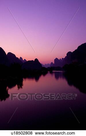 Stock Photo - China, Guangxi Province, Guilin, Yangshuo, Yulong River at sunset. Fotosearch