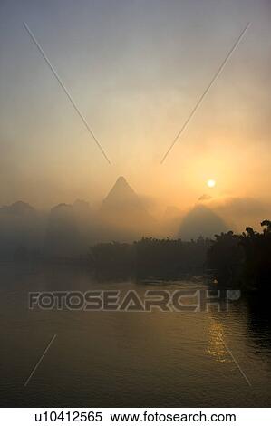 China, Guangxi Province, Guilin, Yangshuo, Li River with mountains at sunrise View Large Photo Image Stock Photography - China, Guangxi Province, Guilin, Yangshuo, Li River with mountains at sunrise. Fotosearch