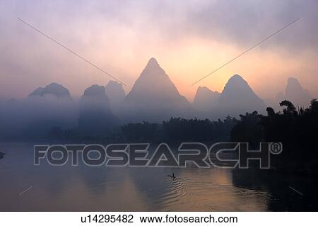 Stock Image - Li River with mountain at sunrise, Yangshuo, Guilin, Guangxi Province, China. Fotosearch