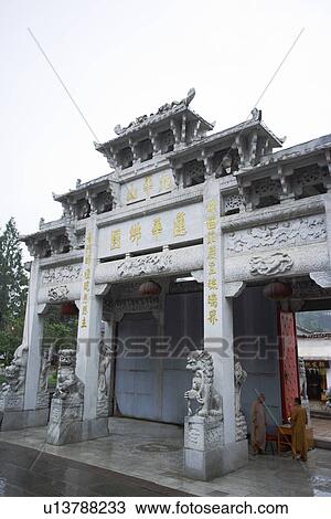Stock Image - People sheltering under memorial gateway. Fotosearch