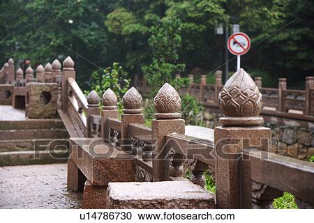 Stock Image - Railing with stone carving. Fotosearch