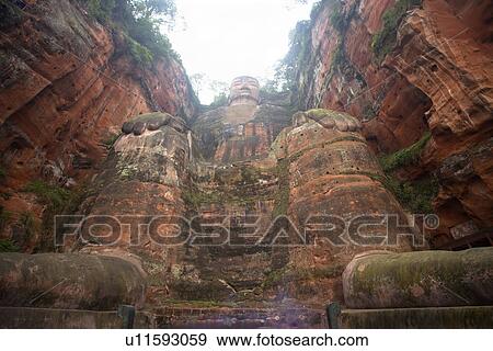 China, Sichuan Province, Leshan, Grand Buddha (Da Fo), low angle view, Largest Buddha in the World. Begun AD 713. by a Buddhist Monk completed 90 years after his death, built to protect fishermen in the Dadu river below. View Large Photo Image Stock Photo - China, Sichuan Province, Leshan, Grand Buddha (Da Fo), low angle view, Largest Buddha in the World. Begun AD 713. by a Buddhist Monk completed 90 years after his death, built to protect fishermen in the Dadu river below.. Fotosearch