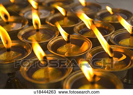Stock Image - China, Sichuan Province, Leshan, Lingyun Temple, lit candles. Fotosearch