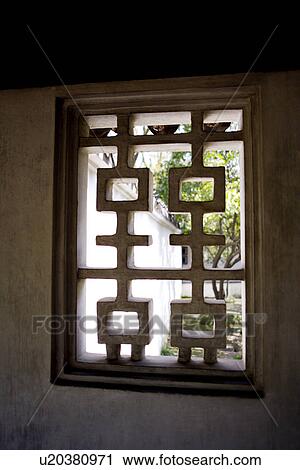 Stock Image - China, Suzhou, The Humble Administrator's Garden, close up of classical window on wall. Fotosearch
