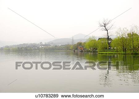 Stock Photo - China, Zhejiang Province, Hangzhou, West Lake in overcast. Fotosearch