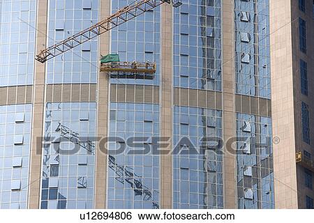 China, Guangdong, Guangzhou, Crane by skyscrapers View Large Photo Image Stock Photograph - China, Guangdong, Guangzhou, Crane by skyscrapers. Fotosearch