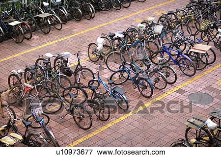 Stock Photo - China, Guangdong, Shenzhen, rows of parked bicycles. Fotosearch