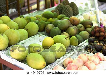 Stock Image - Asia, China, Hainan Island, Sanya, Fruit stall. Fotosearch