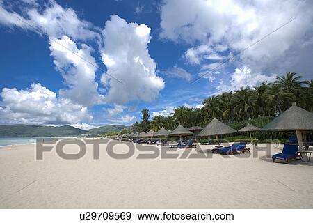 Asia, China, Hainan Island, Yalong Bay, Beach chairs and umbrellas on beach View Large Photo Image Stock Photo - Asia, China, Hainan Island, Yalong Bay, Beach chairs and umbrellas on beach. Fotosearch
