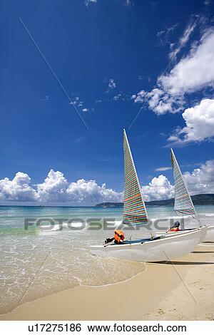 Stock Photograph - Asia, China, Hainan Island, Yalong Bay, Sailboat at seaside. Fotosearch