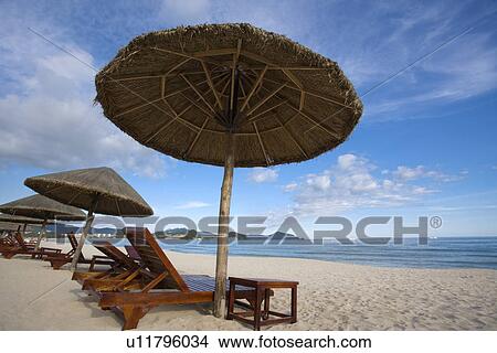 Picture - Beach chairs and umbrellas on beach, Dadong Sea, Hainan Province. Fotosearch