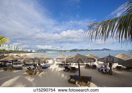 Beach chairs and umbrellas on beach, Dadong Sea, Hainan Province View Large Photo Image Picture - Beach chairs and umbrellas on beach, Dadong Sea, Hainan Province. Fotosearch