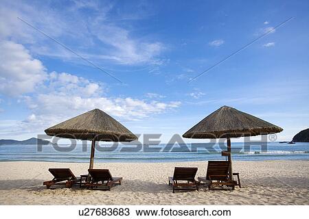 Beach chairs and umbrellas on beach, Dadong Sea, Hainan Province View Large Photo Image Stock Image - Beach chairs and umbrellas on beach, Dadong Sea, Hainan Province. Fotosearch