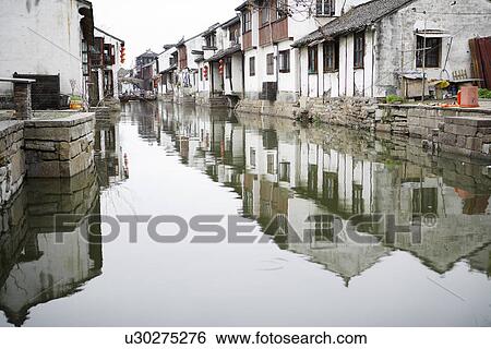 Stock Photograph - China, Jiangsu Province, Kunshan City, Zhouzhuang Town, traditional architecture along river in the water town. Fotosearch