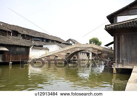 Picture - China, Zhejiang Province, Wuzhen, traditional architecture along the Grand Canal in the water town. Fotosearch