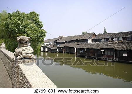 Stock Image - China, Zhejiang Province, Wuzhen, traditional architecture along the Grand Canal in the water town. Fotosearch