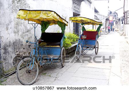 China, Zhejiang Province, Xitang Ancient Scenic Town, rickshaws on house-lined alley View Large Photo Image Stock Photo - China, Zhejiang Province, Xitang Ancient Scenic Town, rickshaws on house-lined alley. Fotosearch