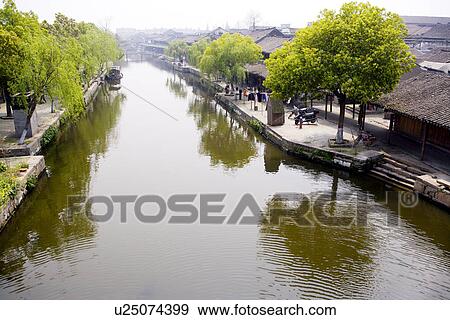 Stock Photo - China, Zhejiang Province, Xitang Ancient Scenic Town, view through canal. Fotosearch