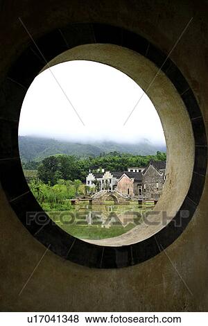 Stock Photo - China, Anhui, Chengkan Village, View through circle window. Fotosearch