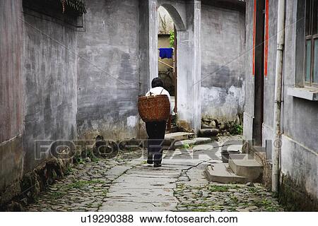 One woman with basket walking on footpath in Cheng Kan Village, Anhui Province, China, Asia View Large Photo Image Stock Photo - One woman with basket walking on footpath in Cheng Kan Village, Anhui Province, China, Asia. Fotosearch