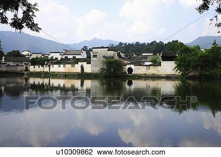 Stock Image - Traditional residential houses with reflection in the river. Fotosearch