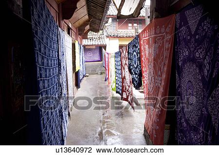 Stock Image - China, Yunnan Province, Baisha Town, Clothing hanging on clothesline. Fotosearch