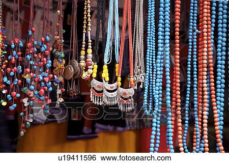 China, Yunnan Province, Baisha town, market stall, necklaces View Large Photo Image Stock Photograph - China, Yunnan Province, Baisha town, market stall, necklaces. Fotosearch