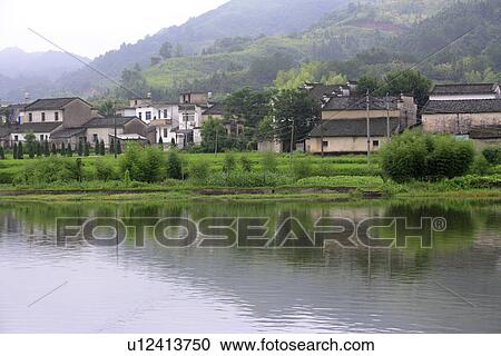 Stock Image - China, Anhui, Residential district at water's edge. Fotosearch